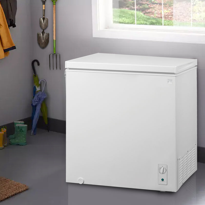 Kenmore convertible chest freezer/refrigerator, closed, below a window in a mudroom with boots and an umbrella to the left