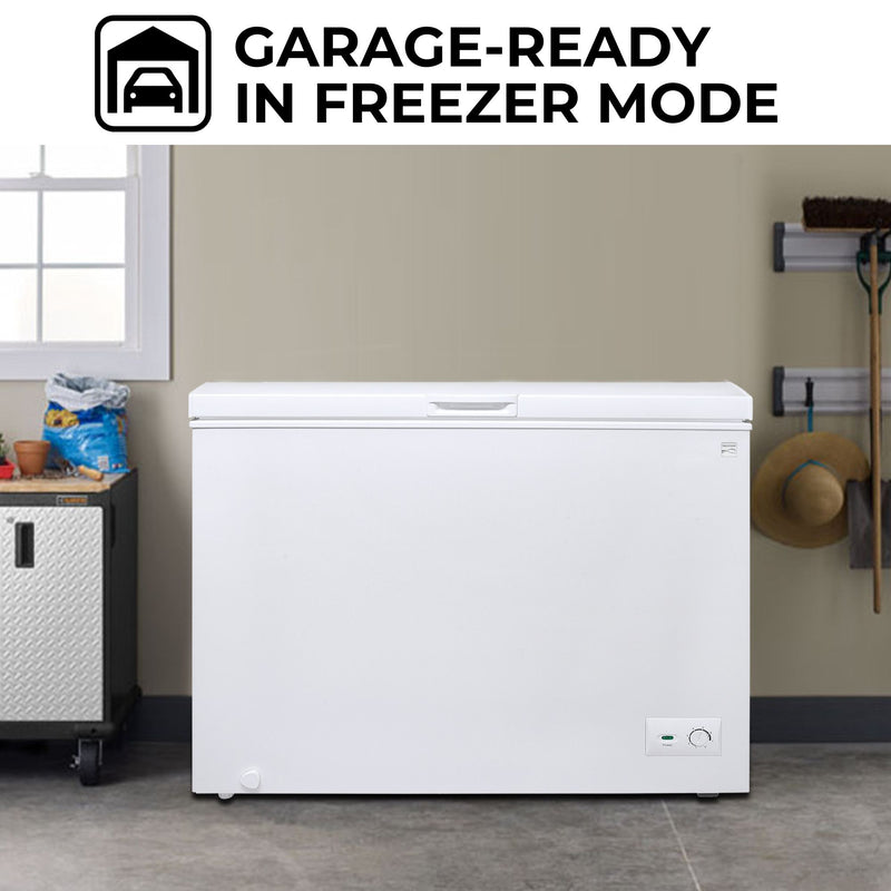 Kenmore chest freezer, closed, in a garage with a white window and beige wall behind and gardening supplies on either side. Text above reads, "Garage-ready in freezer mode"