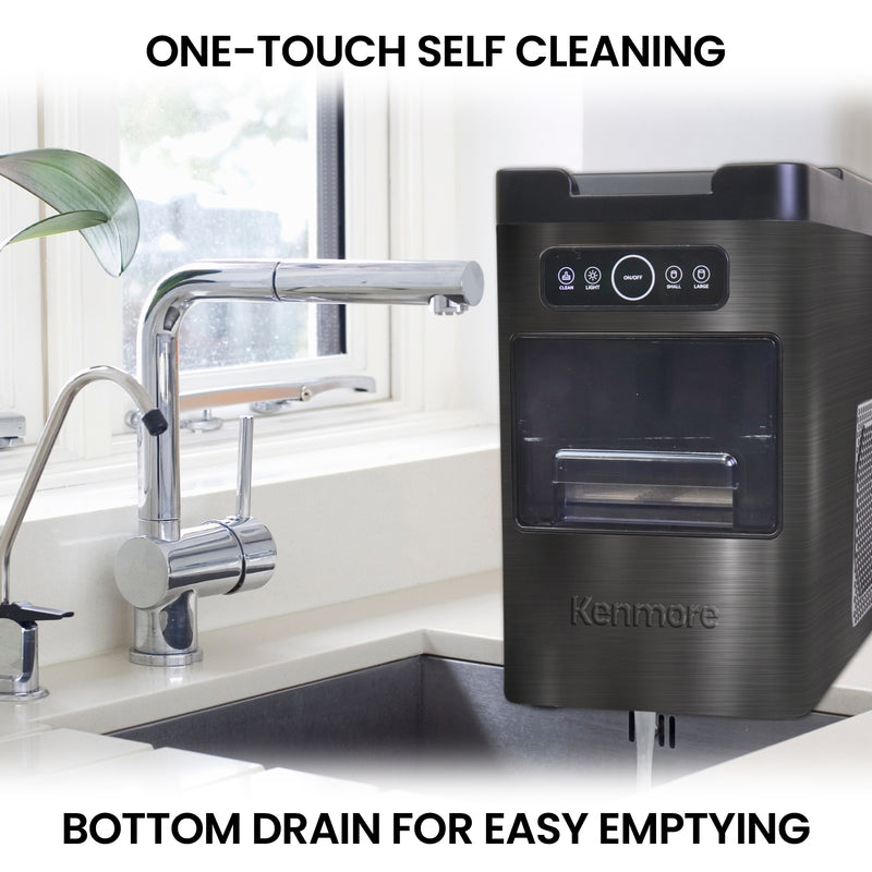 Kenmore front load automatic ice maker on the side of a sink with an inset closeup of the drain on the bottom. Text above reads, "One-touch self cleaning," and text below reads, "Bottom drain for easy emptying"