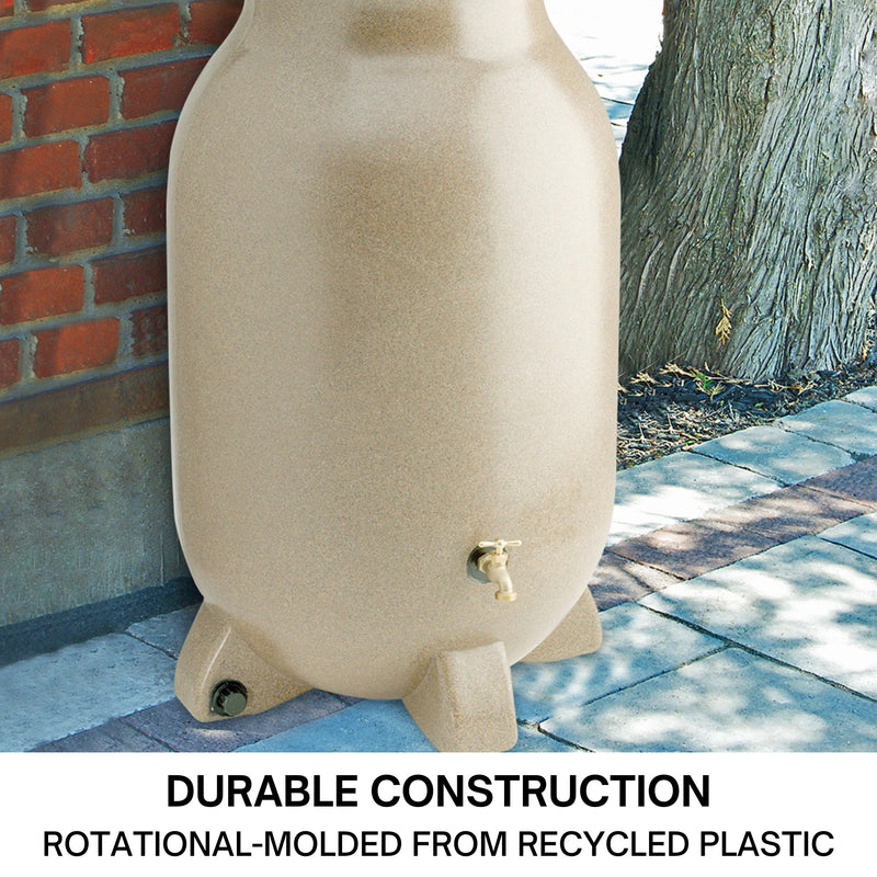 Koolscapes faux sandstone rain collector set up on a concrete path below a white downspout with a red brick wall, tree, and grass in the background. Text below reads, "Durable construction: Rotational molded from recycled plastic."