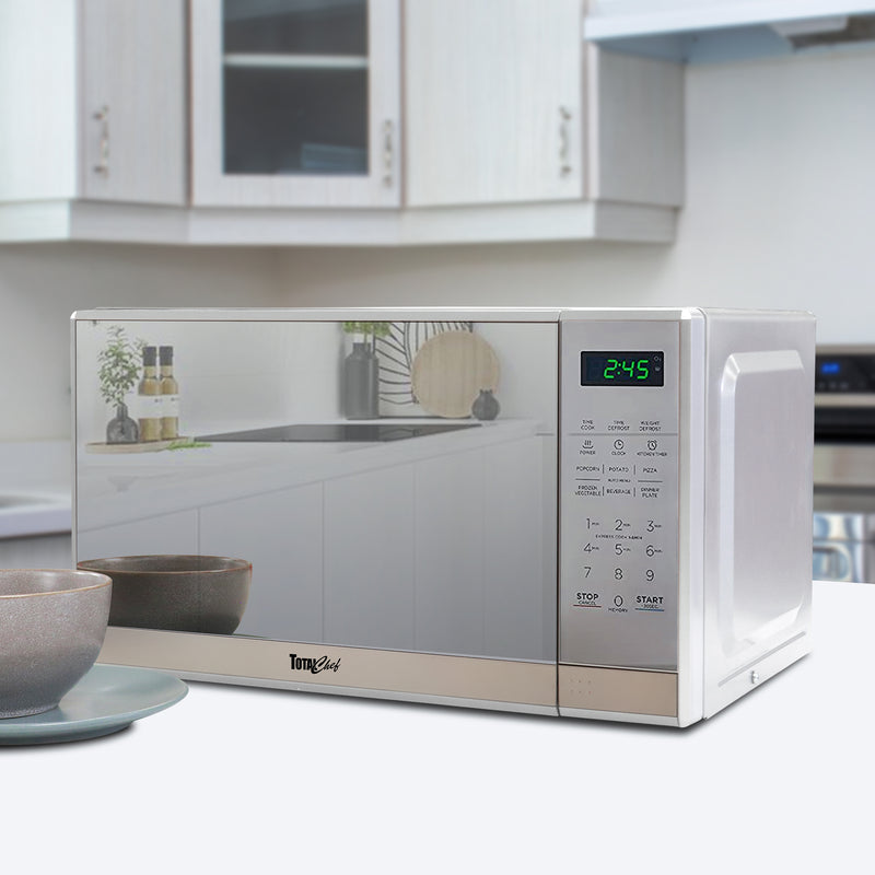 Total Chef 0.7 cu ft stainless steel microwave with mirrored finish in a modern white kitchen